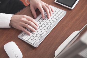 Businessman typing on computer keyboard.