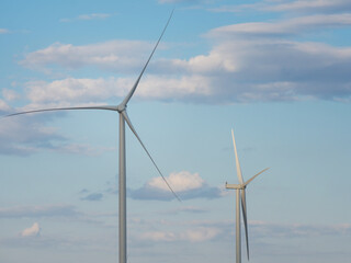 Turbines of wind power generators on a background of blue sky. Alternative energy sources....
