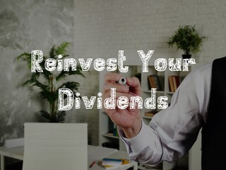 Business concept about Reinvest Your Dividends with phrase on the page.