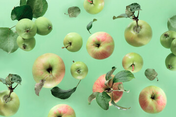 Flying in air Green fresh whole and leaves over green background and light, food levitation concept