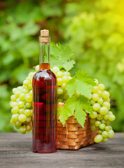 Rose wine bottle and ripe grape