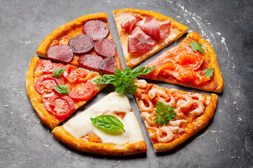Tasty slices of different pizza