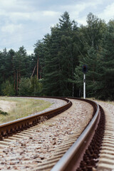 The railway in the countryside. Empty rail track surrounded by trees.