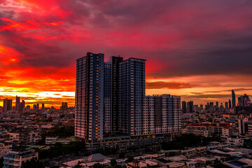 The high angle background of the city view with the secret light of the evening, blurring of night lights, showing the distribution of condominiums, dense homes in the capital community