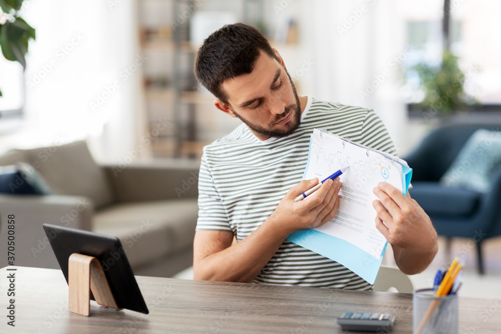 Sticker technology, remote job and lifestyle concept - man with tablet pc computer and papers having video call at home office