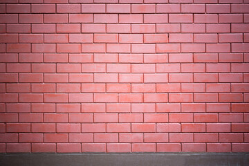 The brick wall of red color with a cement base on the bottom. Ideal for use as a design background or for adding text, brick wall patterns.