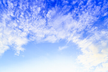 Beautiful fluffy white clouds float in the blue sky on a nice day in summer. Blue is the beautiful color of nature.