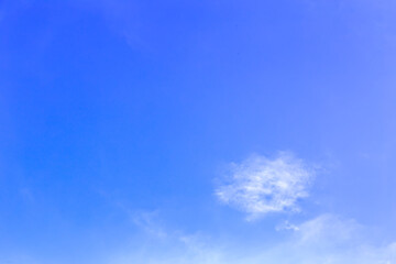 Beautiful fluffy white clouds float in the blue sky on a nice day in summer. Blue is the beautiful color of nature.