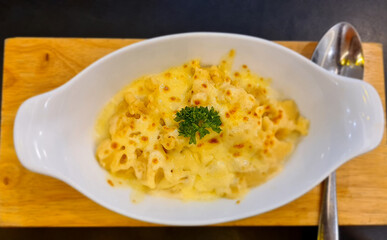Cheese baked potatoes on a white plate