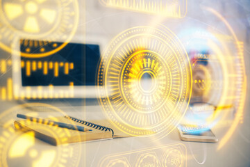 Computer on desktop in office with technology theme hologram. Multi exposure. Tech concept.