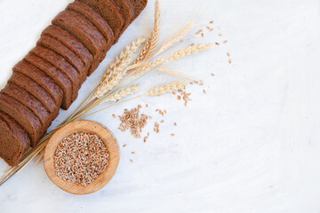 Top view of different loaves of bread and wheat ears copy space