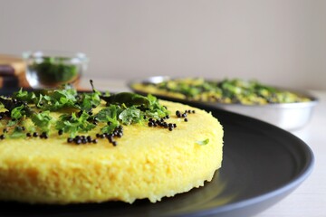 Indian traditional Dal dhokla. Khaman dhokla is a famous dish of Gujarat. Made using rice, healthy mix lentils and pulses, along with spices. garnished with coriander & fried chilies. Copy space.