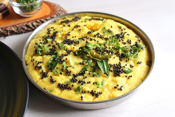 Indian traditional Dal dhokla. Khaman dhokla is a famous dish of Gujarat. Made using rice, healthy mix lentils and pulses, along with spices. garnished with coriander & fried chilies. Copy space.