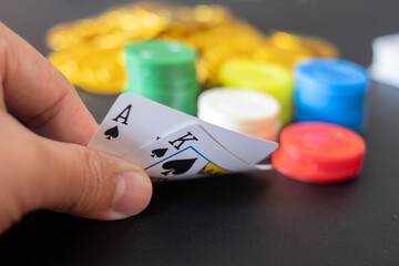 The Casino table with cards showing black jack on hand and blurred casino chips and Gold coin  in the background