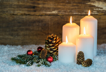 Four white burning christmas or advent candles