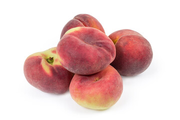 Pile of flat and ordinary peaches on a white background