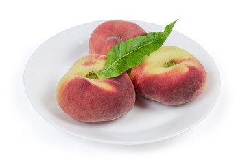 Flat peaches on the white dish on a white background