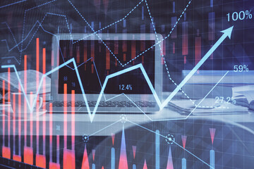 Forex market graph hologram and personal computer on background. Double exposure. Concept of investment.