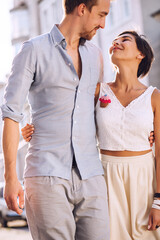 Portrait of attractive couple in love walking in city