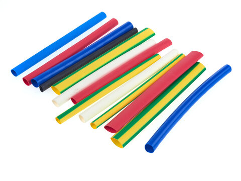 Assortment of heat shrink tubing for electrical insulation, isolated on white background
