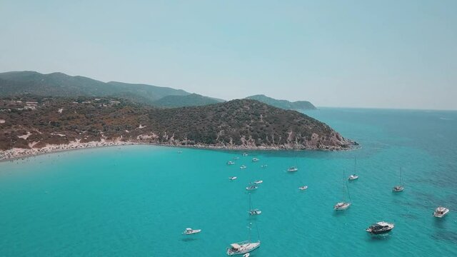 aerial view of sardinia shoreline ( mari pintau ) torquise sea water with clear blue sky in a sunny day during summer season .