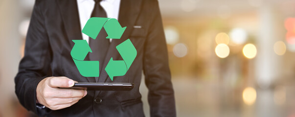 Businessman hand holding mobile phone with logo recycle icon. Concept of save environmental.