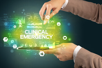 Obraz premium Close-up of a touchscreen with CLINICAL EMERGENCY inscription, medical concept