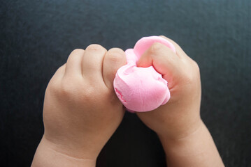 Children's hands are modeling dough for modeling. Children's development and creativity