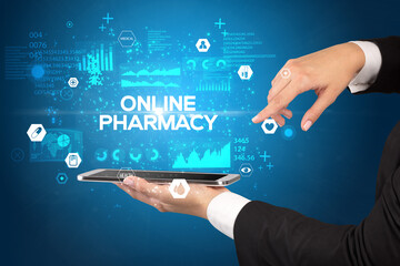 Close-up of a touchscreen with ONLINE PHARMACY inscription, medical concept