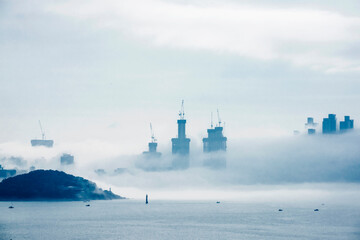 The beautiful beach and bay with thick mist blow from the sea to the land.