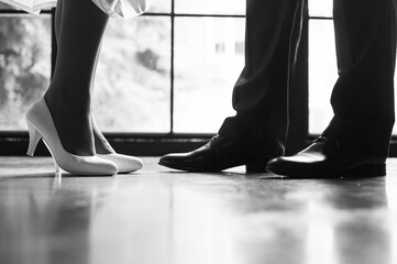 Shoes of the bride and groom at the wedding. Black and white picture