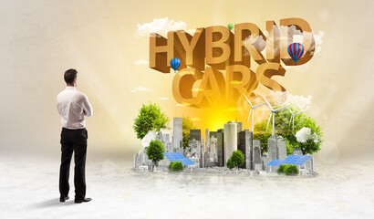 Rear view of a businessman standing in front of HYBRID CARS inscription, Environmental protection concept