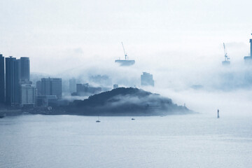 The beautiful beach and bay with thick mist blow from the sea to the land.