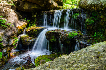 Beautiful waterfall on small river in a park