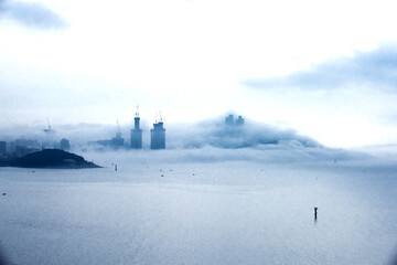 Fototapeta premium The beautiful beach and bay with thick mist blow from the sea to the land.