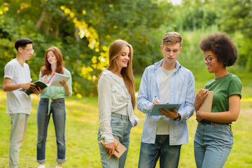 Campus Life. College Students Spending Time Outdoors, Relaxing Or Preparing For Lessons