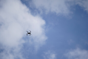 Budapest - Hungary - 03/07/2020. DJI Mavic 2 pro drone, camera captures aerial landscapes on a background of blue sky with white clouds. The Mavic 2 Pro Drone is floating, flying in the sky.