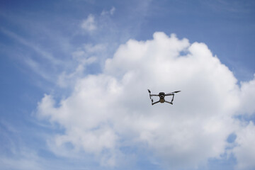 Budapest - Hungary - 03/07/2020. DJI Mavic 2 pro drone, camera captures aerial landscapes on a background of blue sky with white clouds. The Mavic 2 Pro Drone is floating, flying in the sky.