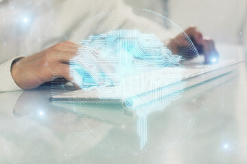 Fototapeta premium Man with computer background with brain theme hologram. Concept of brainstorm. Double exposure.