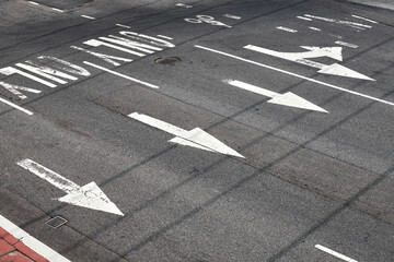 Road surface arrow markings on asphalt in New York City, USA.