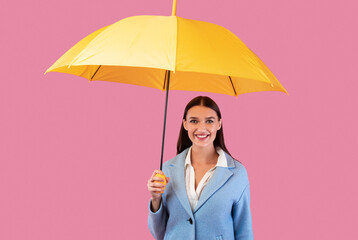 Portrait of cute girl holding yellow umbrella