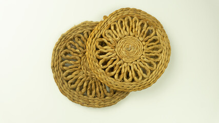 Two jute coaster kept one top of the other on isolated background 