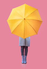 Portrait of young girl holding yellow umbrella © Prostock-studio