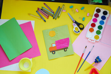 School supplies, stationery on yellow background - space for caption. Child ready to draw with pencils and make application of colored paper. Top view.