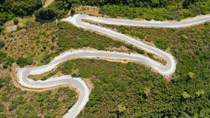 Aerial drone top down photo of snake serpentine road leading to mountain top