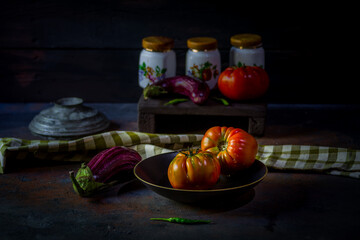 Preparation with vegetables on dark ground in the kitchen