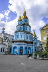 Fototapeta na wymiar Kharkiv, Ukraine - July 20, 2020: Pokrovsky Cathedral in Kharkov with light blue facades and golden roofs, vertical. The oldest Orthodox church in the city. Background with copy space