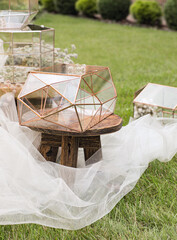 Wedding glass boxes for envelopes for greetings on little wooden table and the  white tissue with plants as a decoration