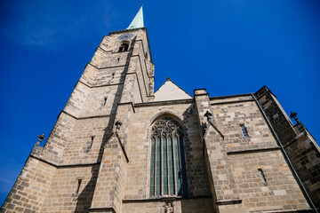 Fototapeta premium St. Bartholomew's Cathedral on the main Republic square of Plzen, Gothic church in old town in sunny day, Pilsen, Western Bohemia, Czech Republic,