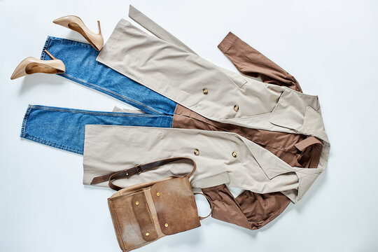 outfir for autumn. women stylish clothes flat lay. beige jacket, blouse and jeans with bag. top view